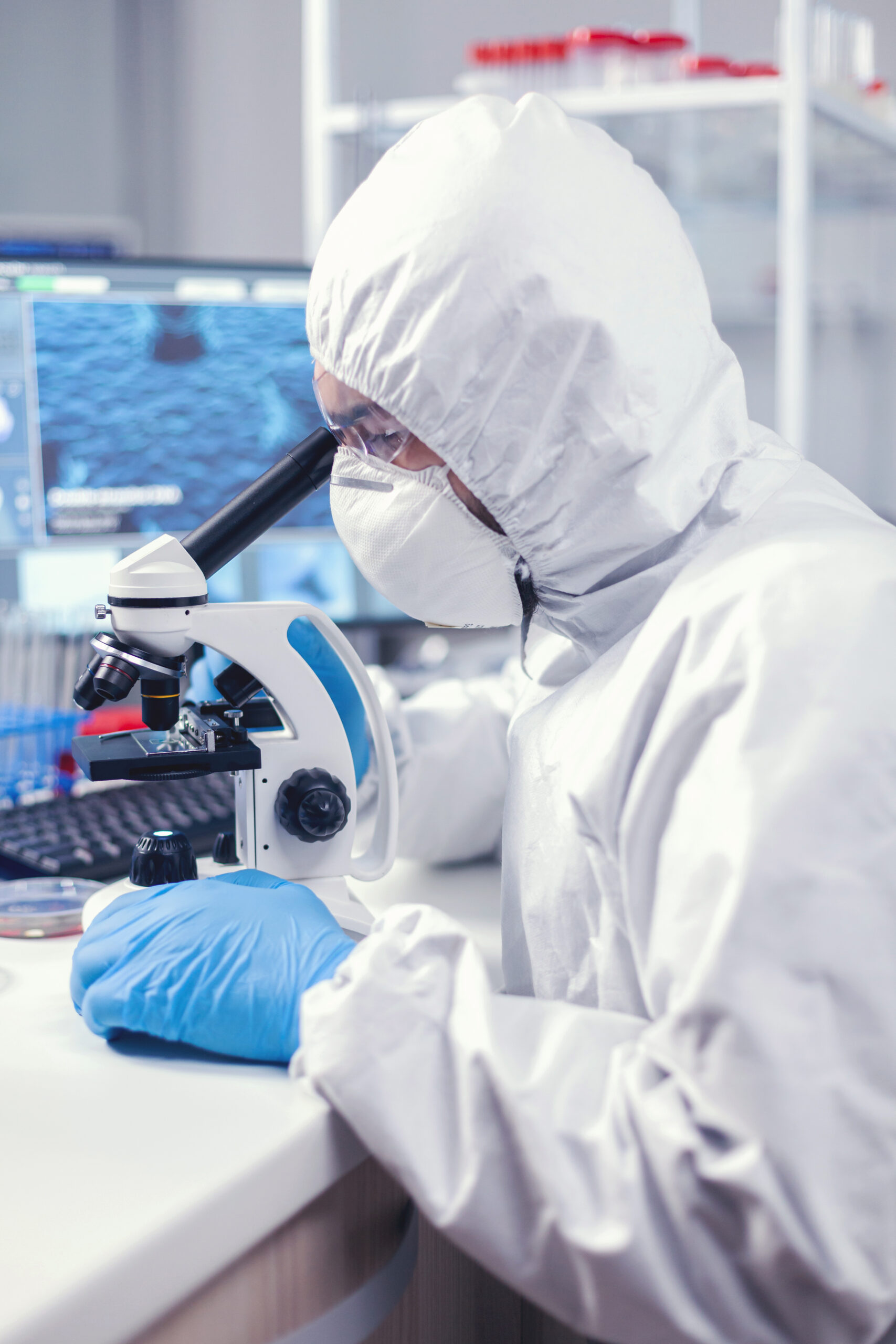 medic in time of global pandemic working on microscope